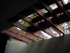 looking up through livingroom ceiling and roof at the sky and trees outside