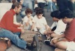 playing the dulcimer sitting on the sidewalk many years ago with kids sitting in front of me