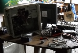 second computer openned with pci cards and tools on the table