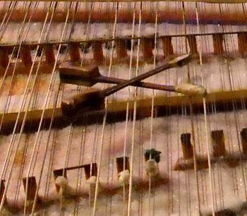 a close-up of the dulcimer hammers sitting on the strings above the snow-covered dulcimer