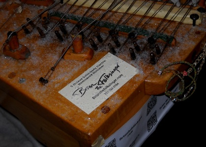 brian the folksinger business card on snowy dulcimer at night