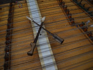 the dulcimer hammers sitting crossed on the strings, their normal place