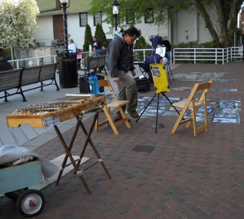a view of the dulci setup on the street with the portrait artists set up alongside beyond it