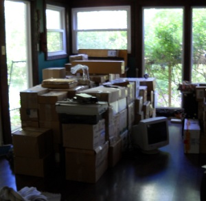 the pile of boxes from the van stacked in the dining room