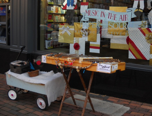 dulci on street with music is in the air in shop window display