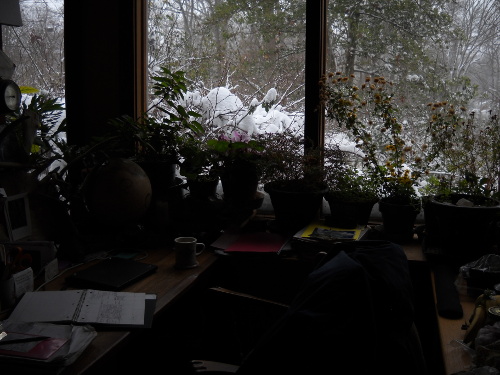 my desk and journal, snow outside the window