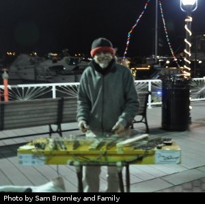 brian looking up and smiling while playing on the waterfront at night, photo contributed by Bromley Family