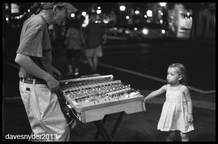 Brian performing on King Street at night, a black and white photo by David Snyder